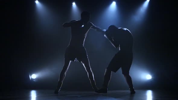 Two Young Sportsman Are Boxing in the Studio, Slow Motion