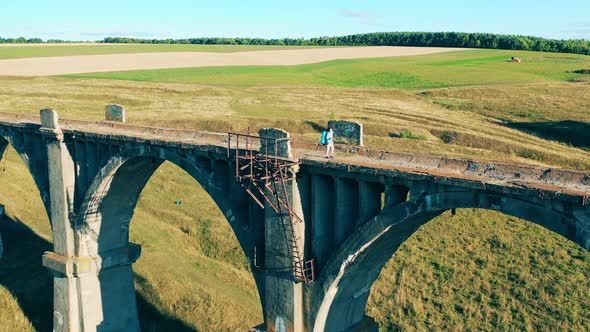 Sports Tourist Is Having a Walk Over a Massive Bridge