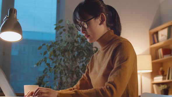 Asian Businesswoman Working Late in Office