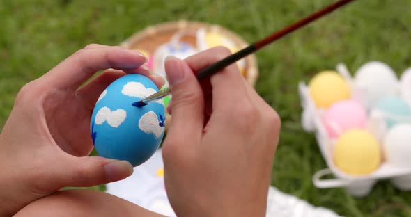 Drawing on egg for Easter holiday at outdoor