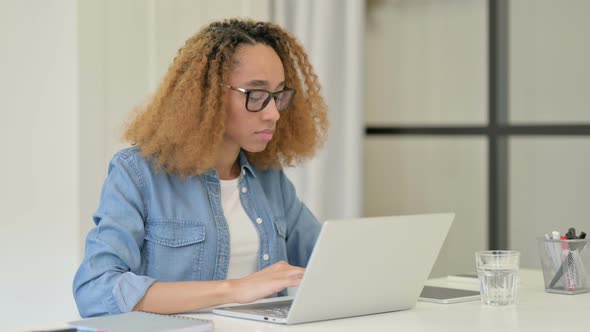 African Woman Drinking Water at Work