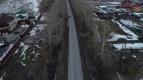 Aerial view of a cars drives along a road near the cottage village 07