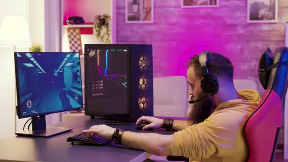 Bearded Man Playing Online Video Games on His Pc