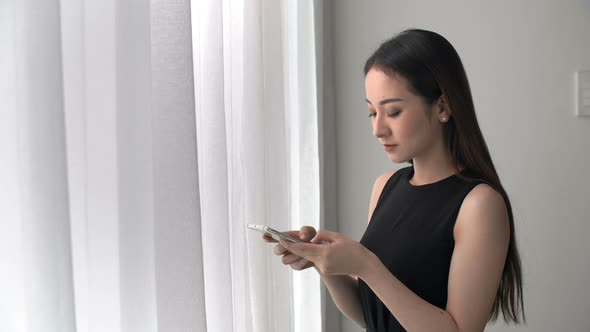 Young Asian Woman Using Smartphone