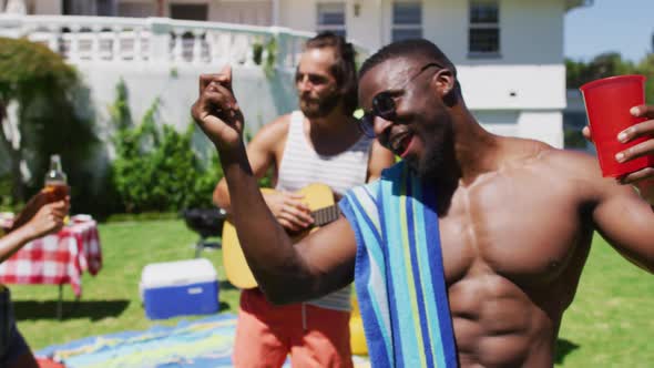 Diverse group of friends having fun and dancing at a pool party