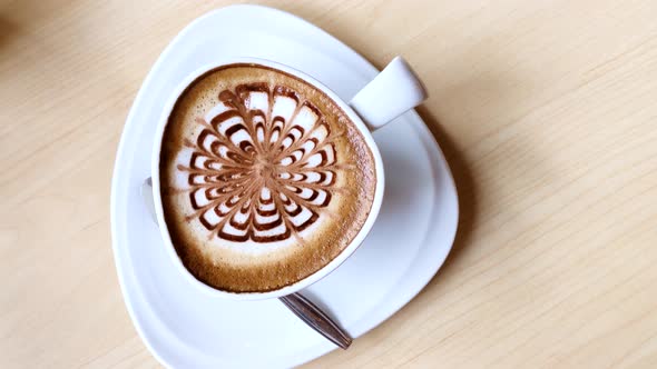 hot coffee on table / hot cappuccino with nice pattern milk foam 