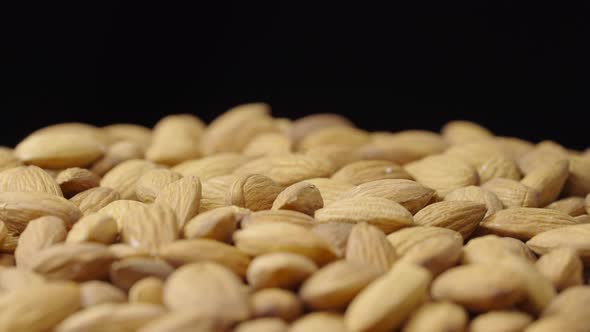 A Handful of Dried Almond Rotate on Black Background