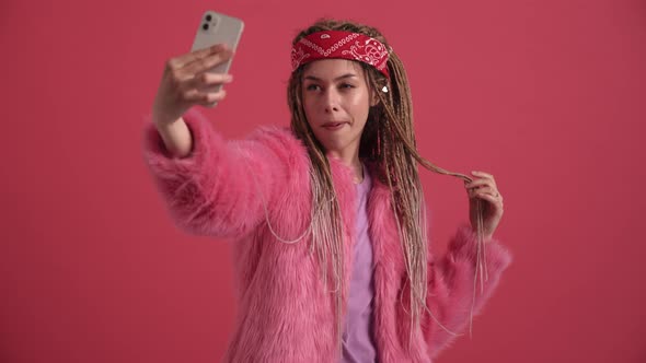 Handsome hippie woman making selfie by mobile