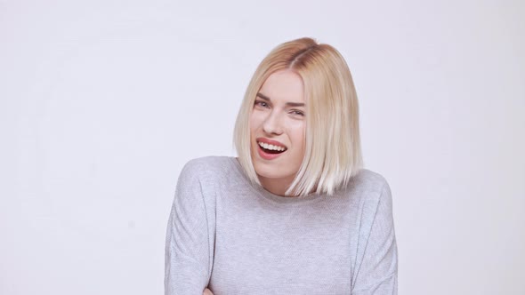 Young Beautiful Critical Blond Girl Pretending She Heard Nothing White Background