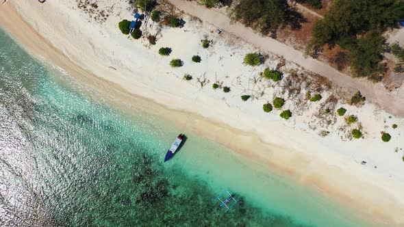 Top down view of amazing shoreline of tropical island with secluded exotic beach washed by calm clea