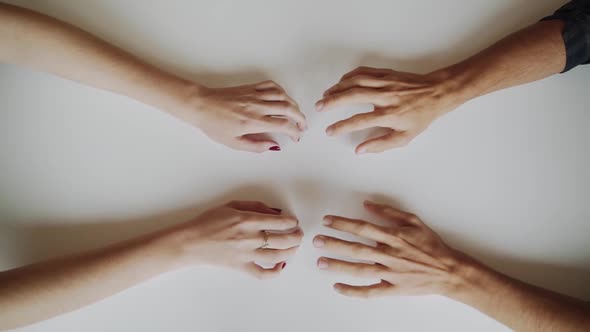 Caucasian Male and Female Hands Move Towards Each Other and Intertwine