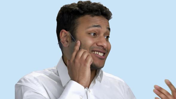 Excited Businessman Talking on Transparent Phone