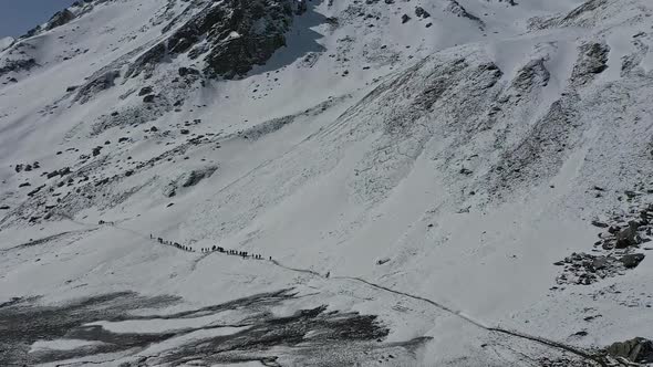 Hikers Trekking Through Steep Mountain Trail Of Sar Pass  Aerial Shot