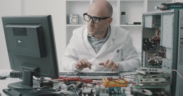 Angry technician working on a broken computer