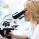 Young Scientist Looking Through Microscope in Laboratory - VideoHive Item for Sale