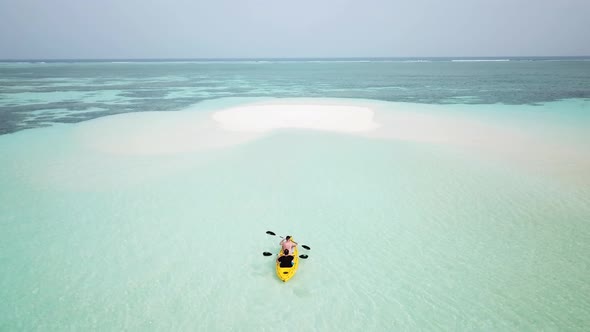 Yellow Kayak Rowing Close to a Sandbar Moving to an Uninhabited Island