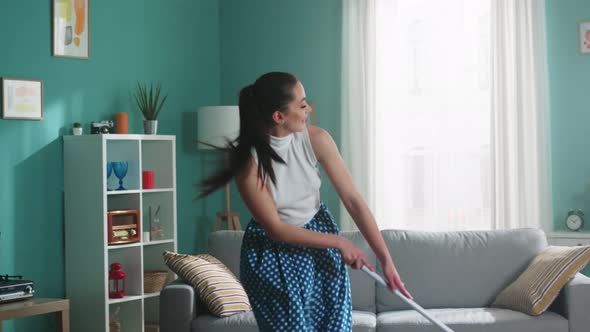 Woman Is Cleaning Floor and Dancing