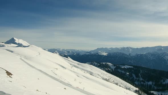 Winter Mountains Panorama with Ski Slopes and Ski Lifts on a Sunny Day