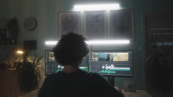 Video Editor Working in Dark Home Office