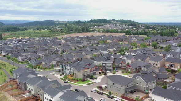 Aerial flying above middle class American houses in a subdivision in a suburb of Portland, Oregon.