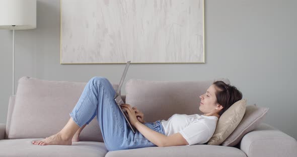 Side View of Female Student Doing Homework Online on Pc Laptop Copy Space