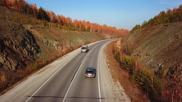 Aerial View of Car Driving on Sunny Fall Country Road Highway