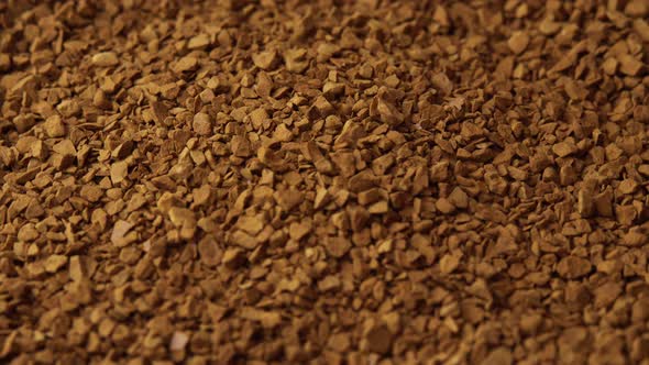 Granules of Instant Coffee Sprinkled on a Plate Closeup Spinning As a Backdground for a Coffee Shop