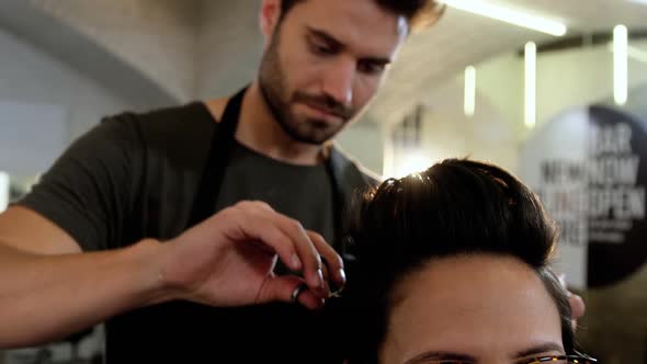 Woman getting her hair trimmed