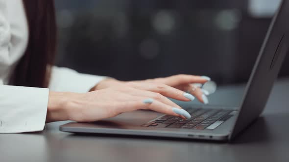 Manicured Female Hands Typing on Laptop