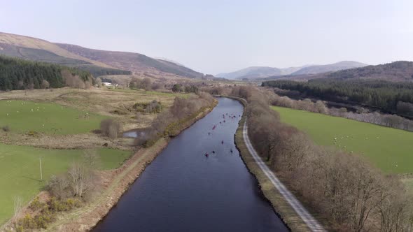 A Group of Canoeists Travelling Along a Canal