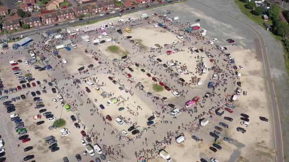 Floating high aerial drone shot towards a busy market and car boot sale in Hull England UK