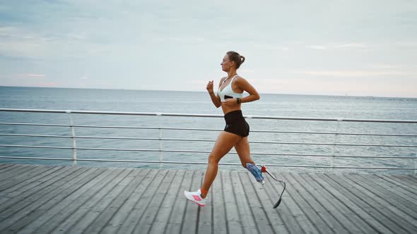 Motivated Disabled Girl Running at Seaside Side View Slow Motion