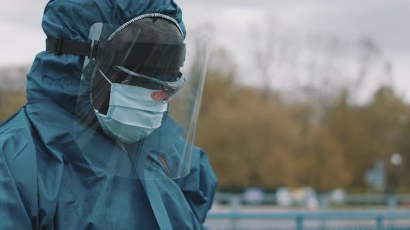 Portrait of African Man with Protective Suit Disinfecting the Streets