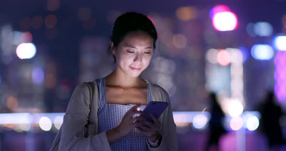 Woman Use of Mobile Phone for Mobile App at Night