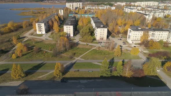 Aerial view of alley near the pond in a provincial autumn town 23