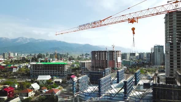 Aerial view of construction site with crane and building.