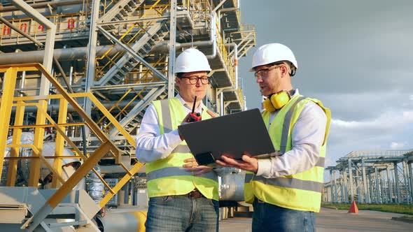 Oilfield Engineers in Hardhats are Using Communication Devices