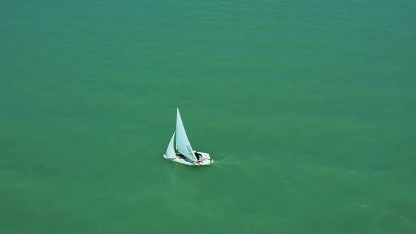 Passing and closer afternoon drone view from a little sailboat near the shore of Zamárdi, Lake Balat