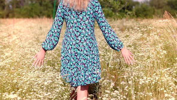 Woman With Bouquet Enjoying Summer In Meadow. Female Sniffs Bouquet Of Wildflowers. Flower.