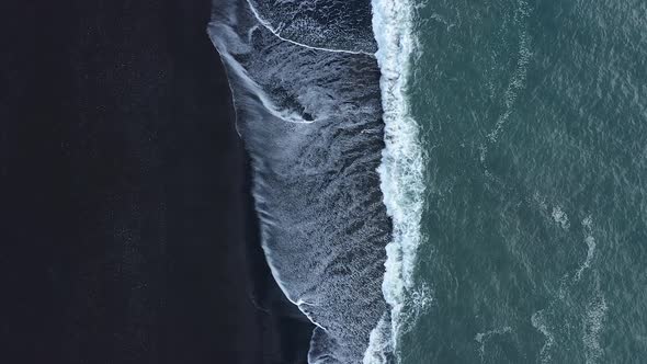 Waves in the ocean. Black sand. Black beach. Waves on the black sand. The nature of Iceland.