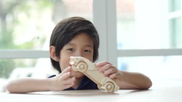 Cute Asian Child Playing Wood Model Cars Slow Motion 
