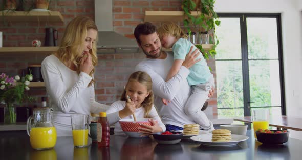 Family preparing food on worktop in kitchen at comfortable home 4k