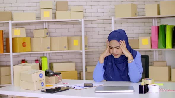 Frustrated young Muslim woman having problem with start up small business