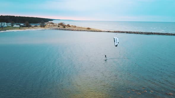 Aerial Drone View of a Corekites Kitesurfers Hydrofoiling  in Engure Port at in Baltic Sea