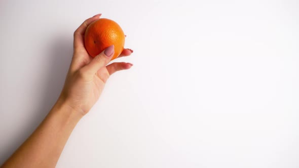Hands holding mandarin. Close up of woman hands holding tangerine
