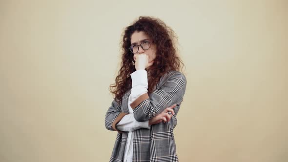 Serious Young Woman with Her Mouth in Her Mouth She is Looking for New Ideas for Development