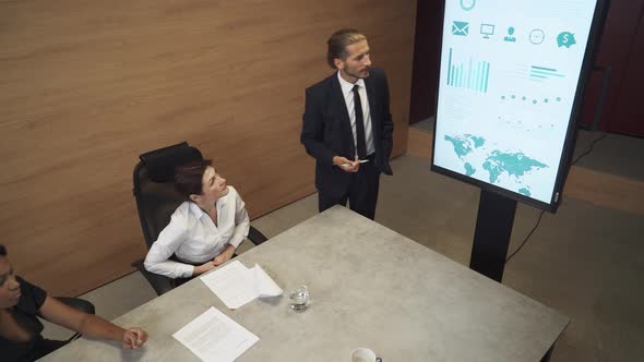 Business Meeting in Office, Young Businessman Speak at a Meeting and Shows Financial Infographic in