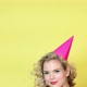Young woman in party hat blowing party horn blower - VideoHive Item for Sale