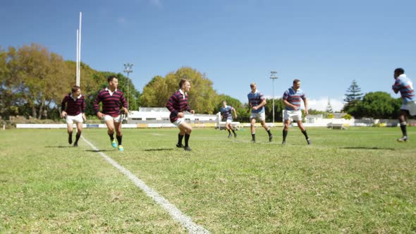 Rugby players tackling during game