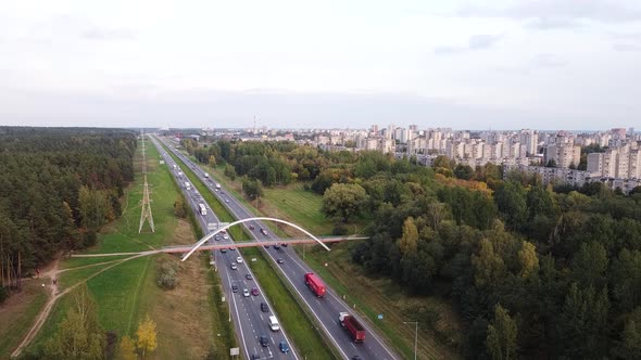 Static drone shot of Kaunas city residential district over the A1 highway with heavy traffic and ped
